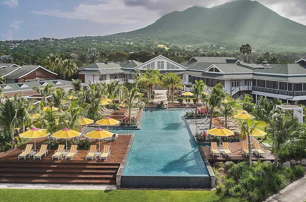 Four Seasons Resort Nevis drone view of infinity pool with Nevis Peak in the background.
