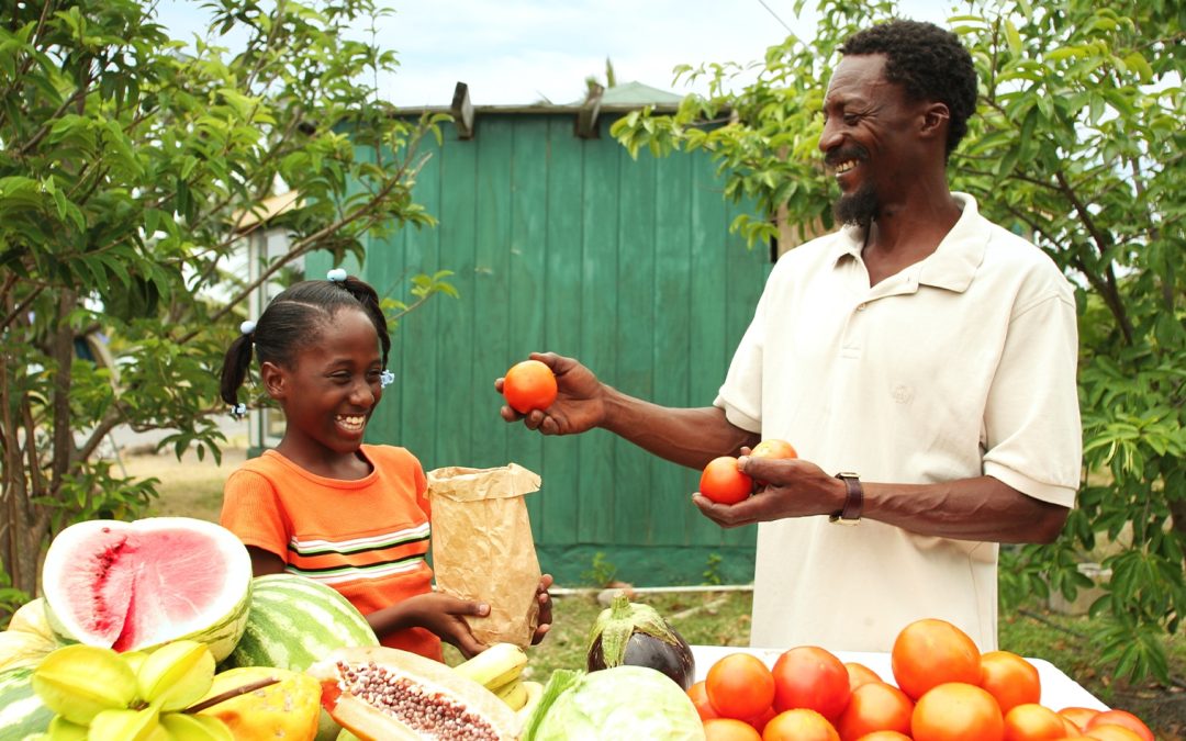 man and child holding fruit