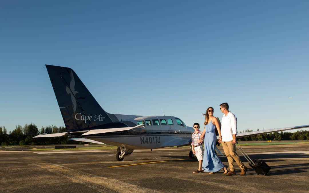 family next to a plane